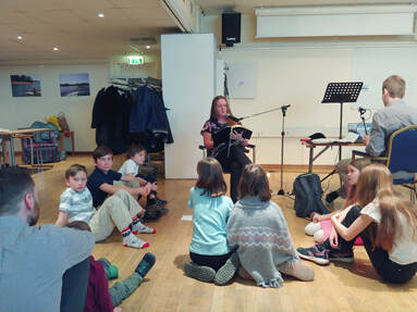 Kaisa leading the devotional for children during the Sunday worship service